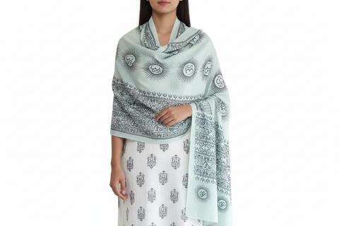 Woman wearing a light blue patterned scarf on a white background