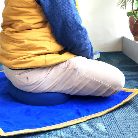 Meditation cushion styled in use showing posture support