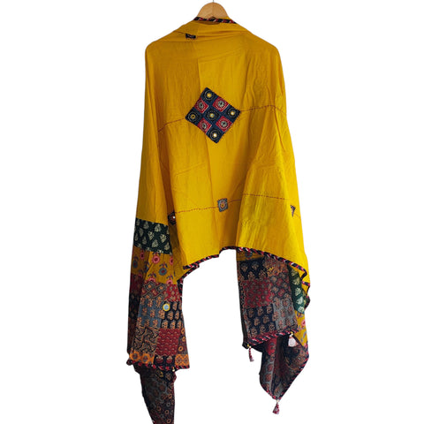 Close-up of hand mirror-work applique and Ajrakh patchwork border on mustard dupatta