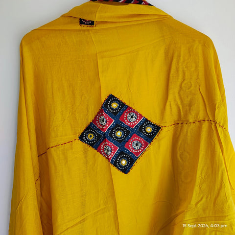 Close-up of hand mirror-work applique and Ajrakh patchwork border on mustard dupatta