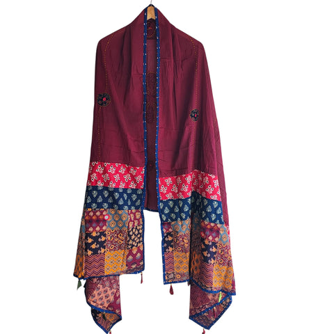 Close-up of hand mirror-work applique and Ajrakh patchwork border on maroon dupatta