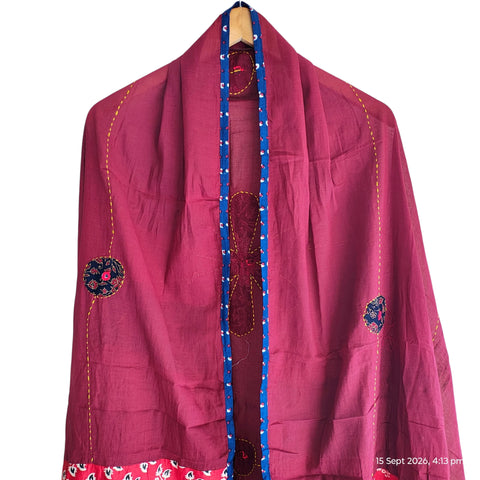 Close-up of hand mirror-work applique and Ajrakh patchwork border on maroon dupatta