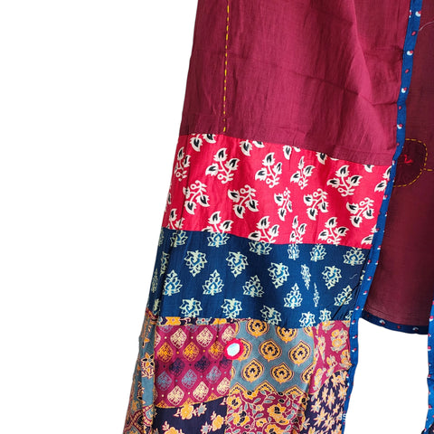 Close-up of hand mirror-work applique and Ajrakh patchwork border on maroon dupatta