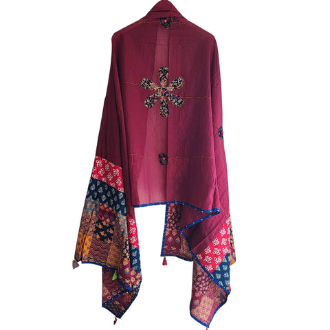 Close-up of hand mirror-work applique and Ajrakh patchwork border on maroon dupatta