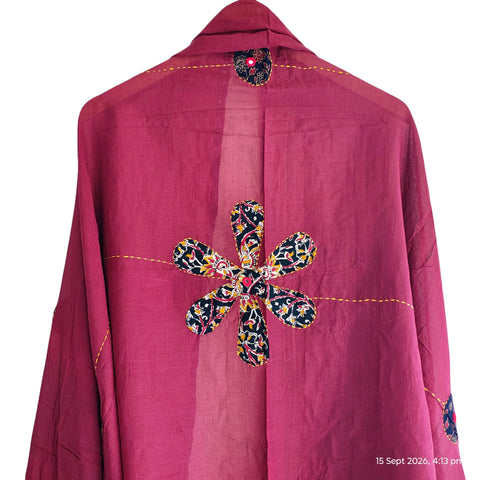 Close-up of hand mirror-work applique and Ajrakh patchwork border on maroon dupatta