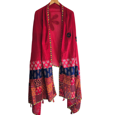 Close-up of hand mirror-work applique and Ajrakh patchwork border on red dupatta