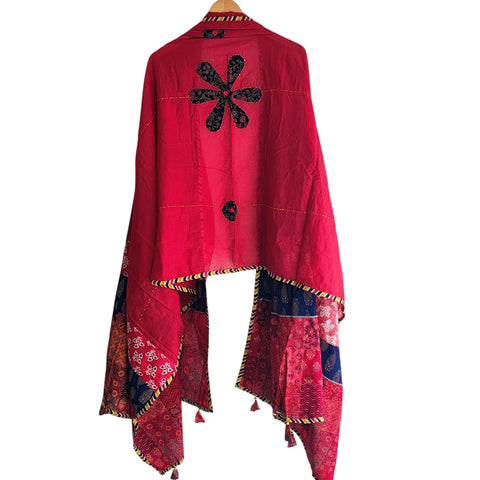 Close-up of hand mirror-work applique and Ajrakh patchwork border on red dupatta