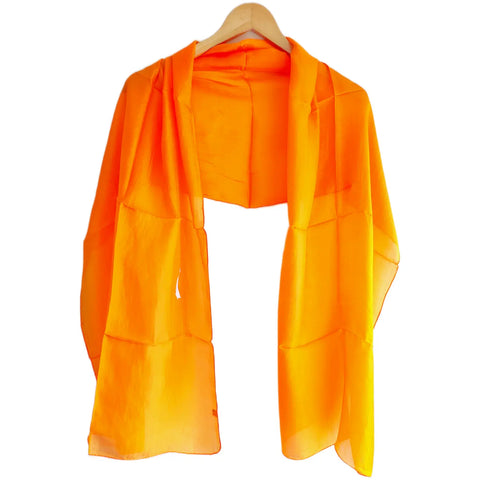 Bright orange solid silk stole draped on shoulders — lightweight Varanasi silk wrap for women, 200x55 cm
