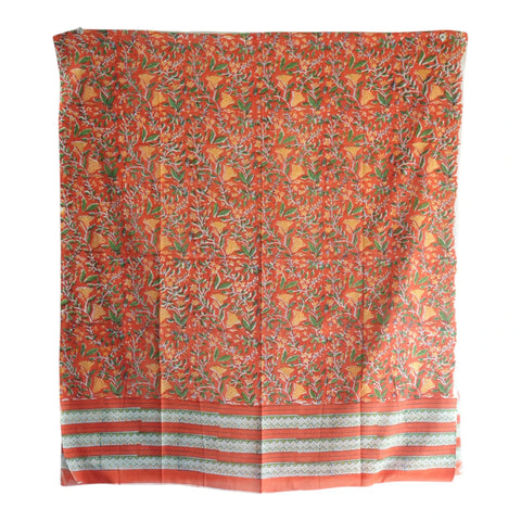 Close-up of green and yellow tropical floral Sanganeri block print on rust mul cotton – ISYVSK-A10
